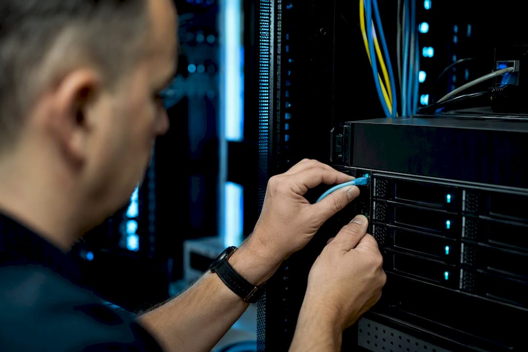 Hands connecting network storage cable
