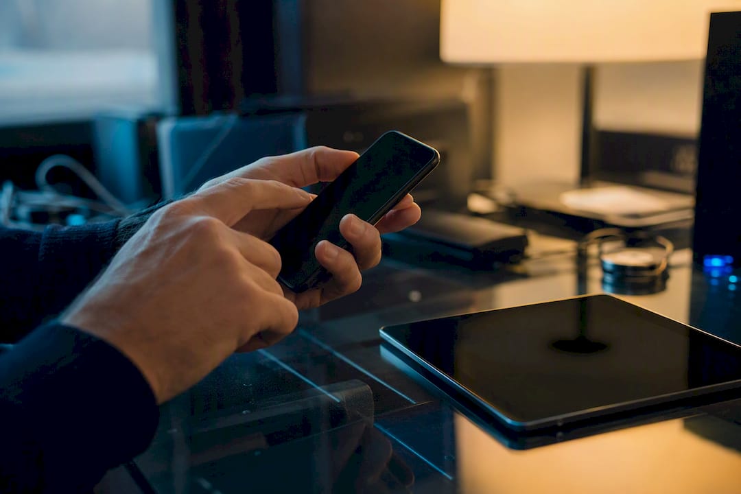 Hands initiating remote wipe on mobile device