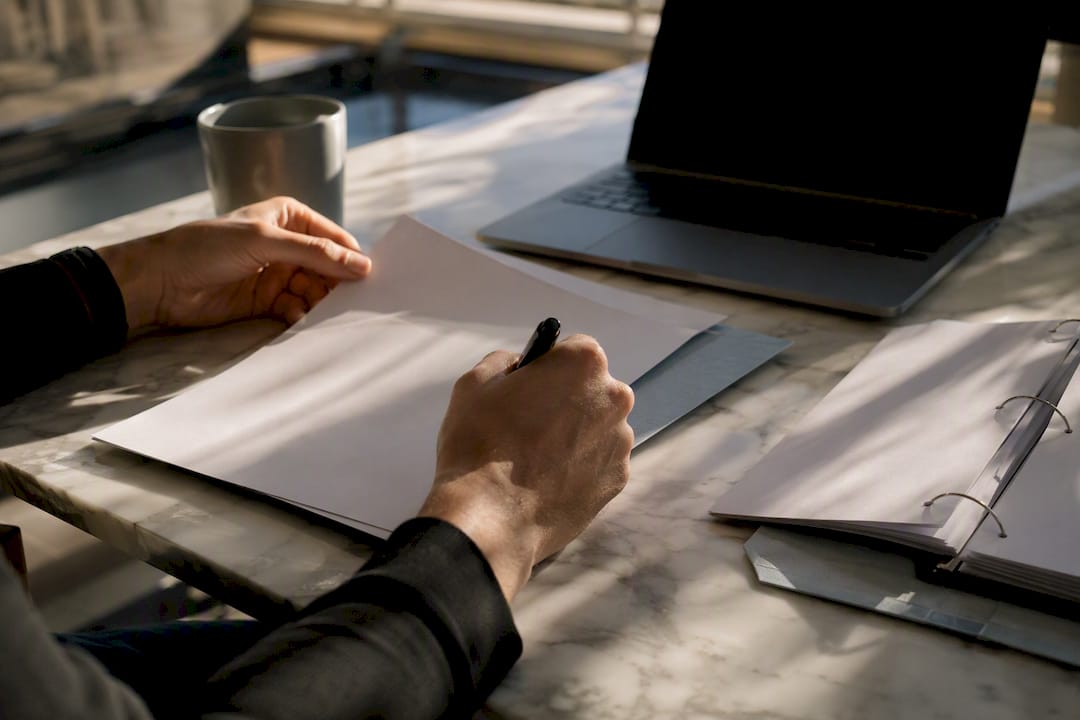 Hands reconciling ecommerce financial records