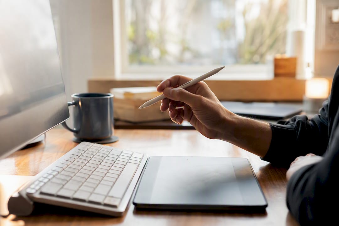 Hand pointing at analytics graph with stylus