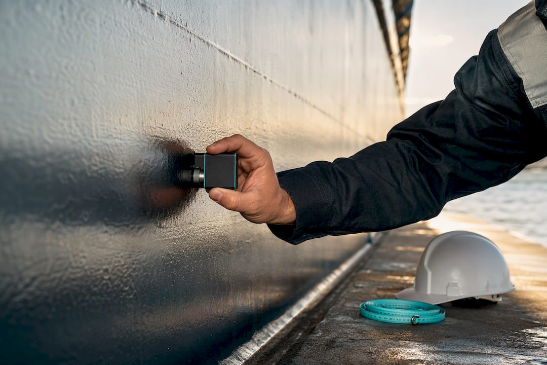 Surveyor inspecting vessel hull for appraisal