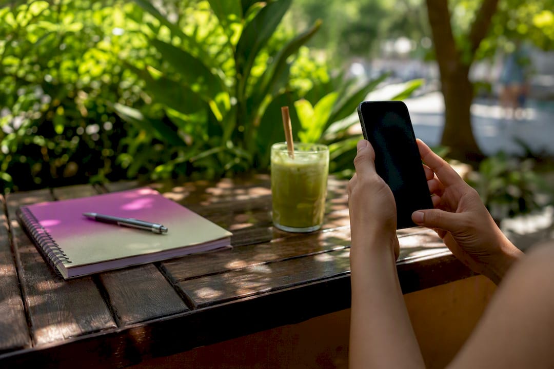 Hand taking screenshot of a social media caption