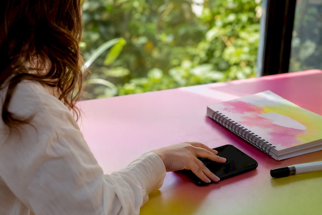 Hand pausing while adjusting social media captions