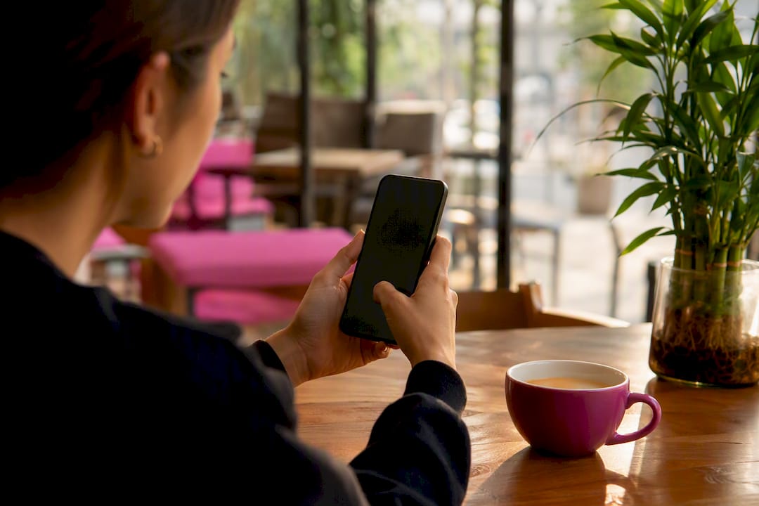 Hand tagging products on Instagram post via smartphone