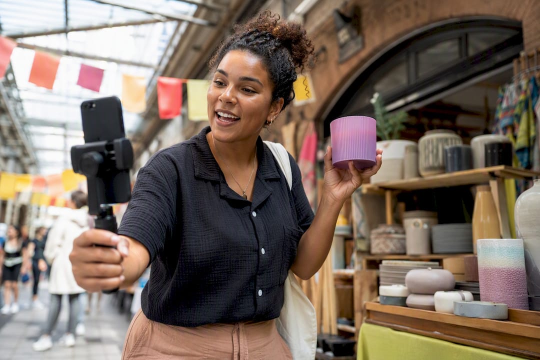 Small shop owner filming TikTok video with smartphone tripod