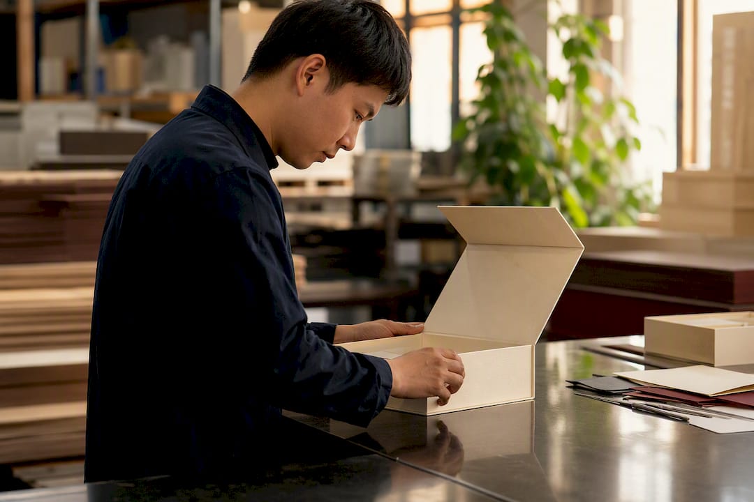 Inspector examining foil embossed rigid box sample