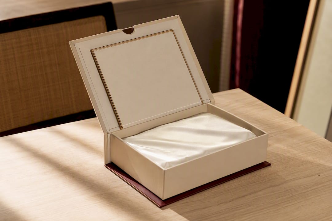 Sculptural hinged perfume box partially opened