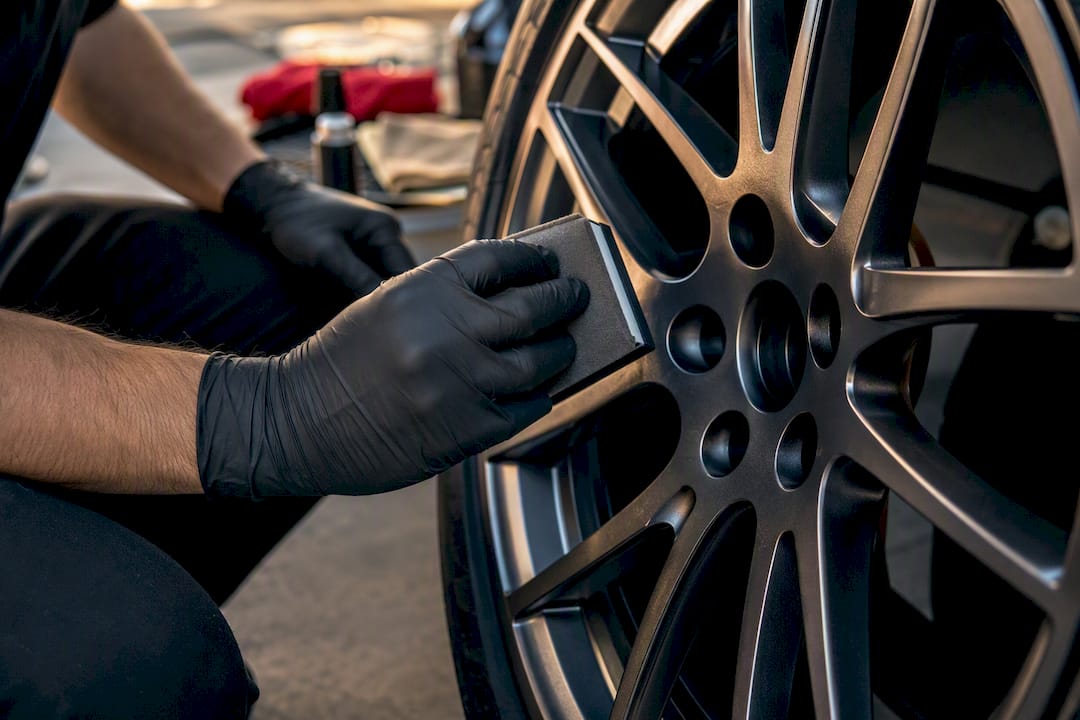 Technician applying ceramic coating on wheel