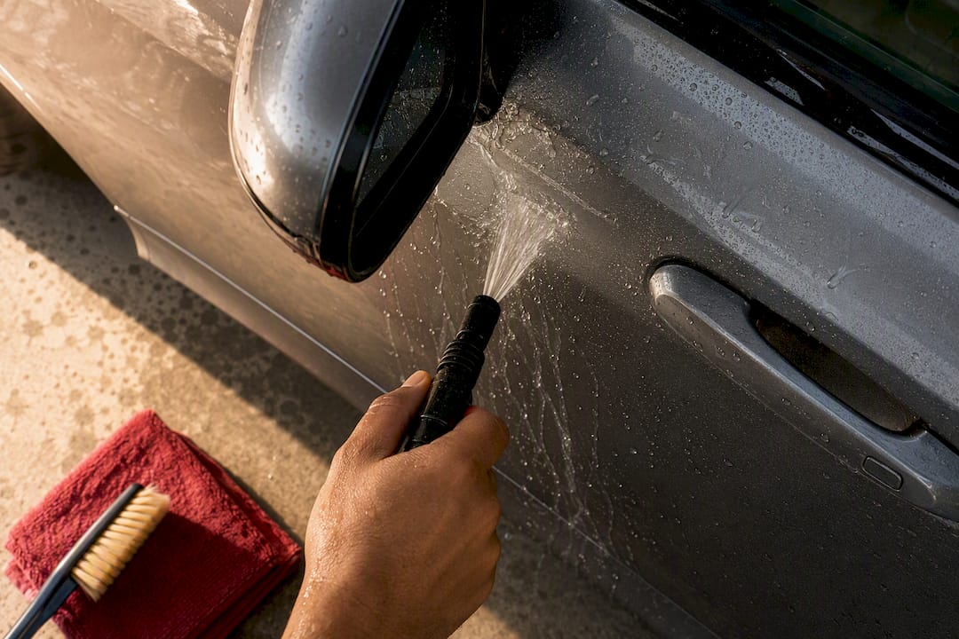 Technician rinsing exposed PPF edges