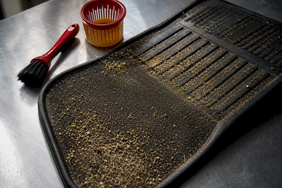 Pollen and grit trapped in vehicle floor mat