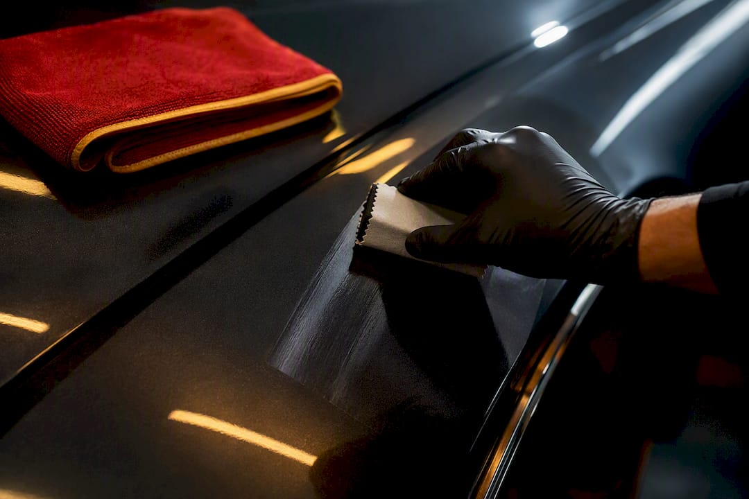 Technician applying ceramic coating to paint