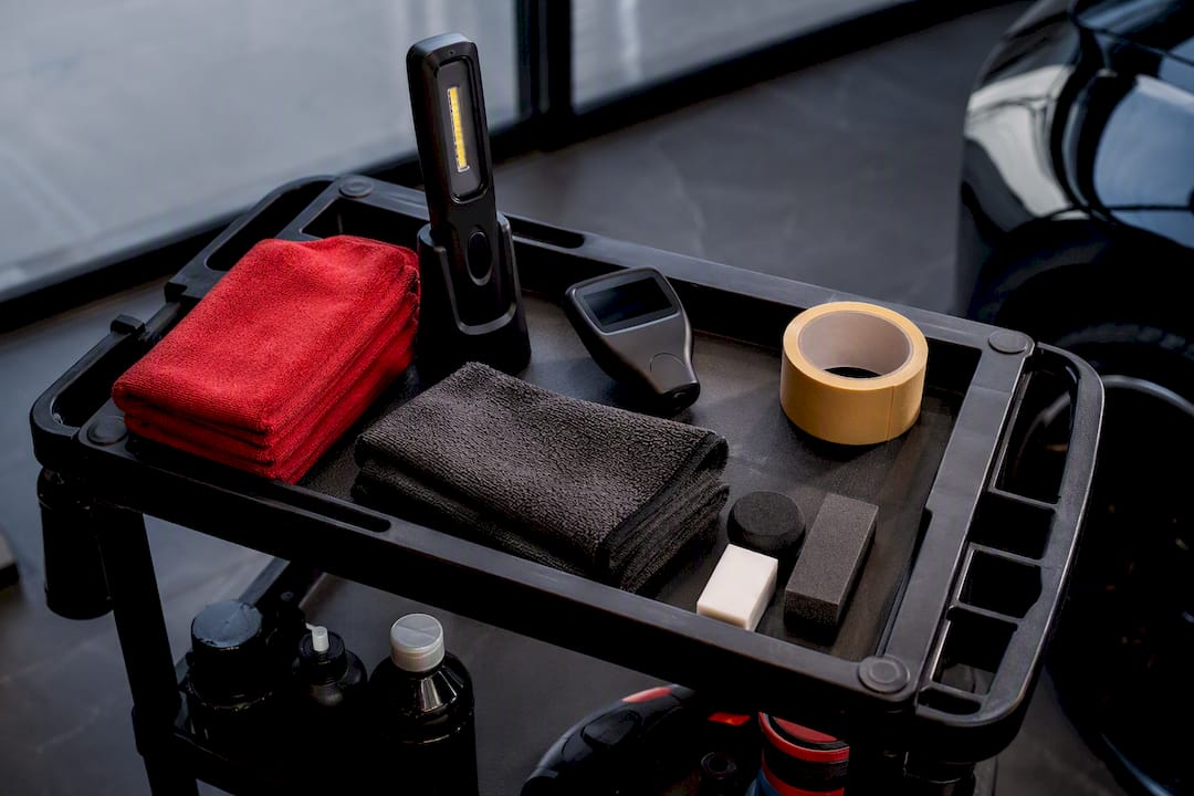 Paint correction tools arranged on detailing cart