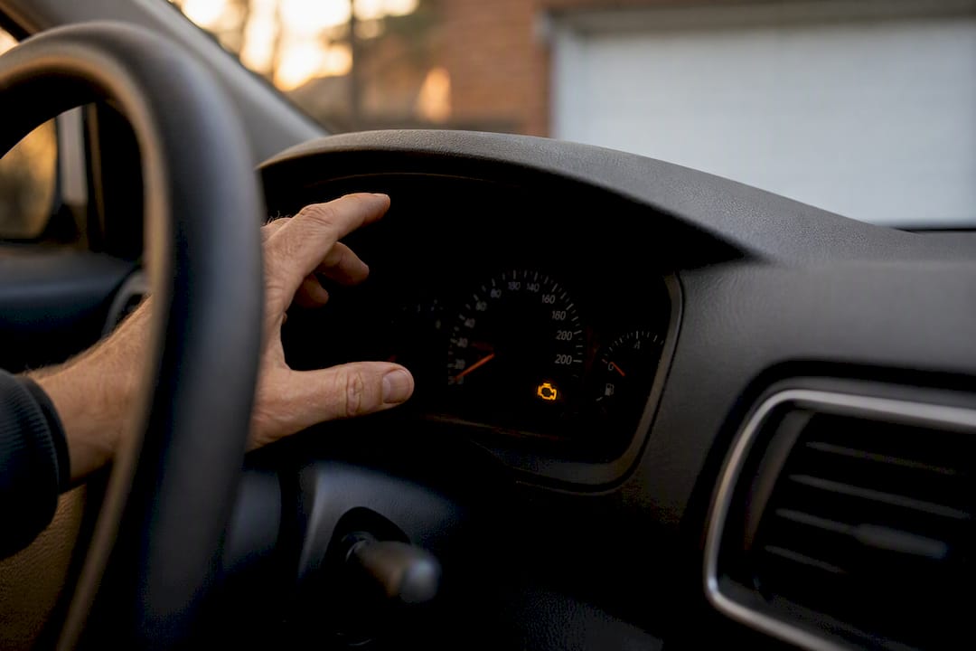 Car dashboard engine check light illuminated