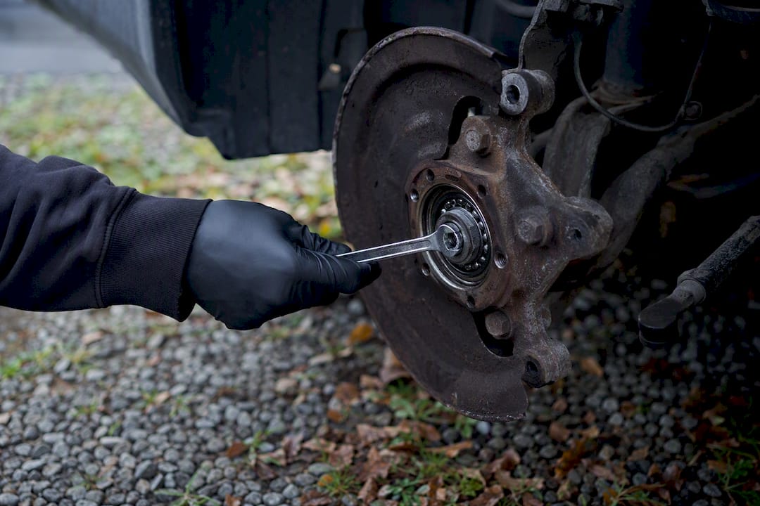 Hand checking wheel bearing with wrench