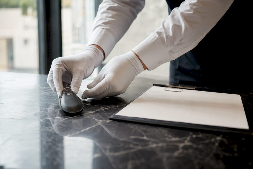 Concierge hands managing vehicle keys and checklist