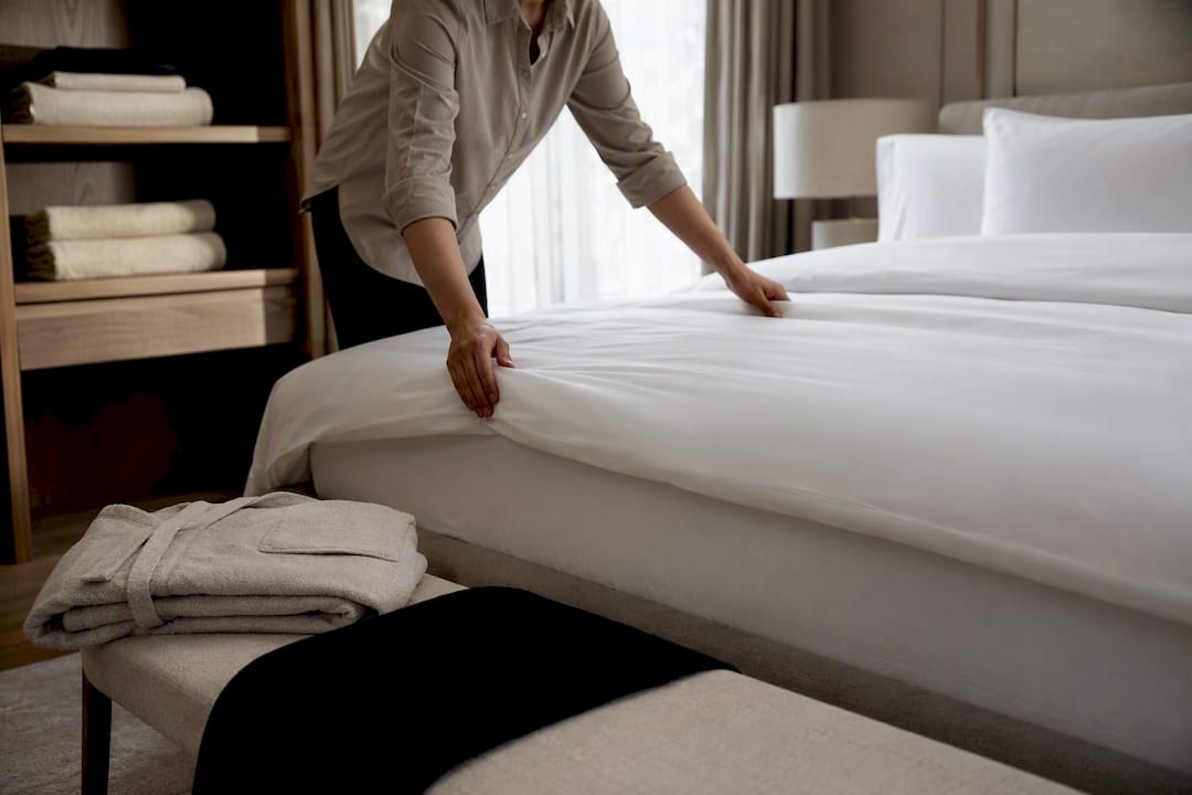 Fresh linens prepared in a luxury bedroom