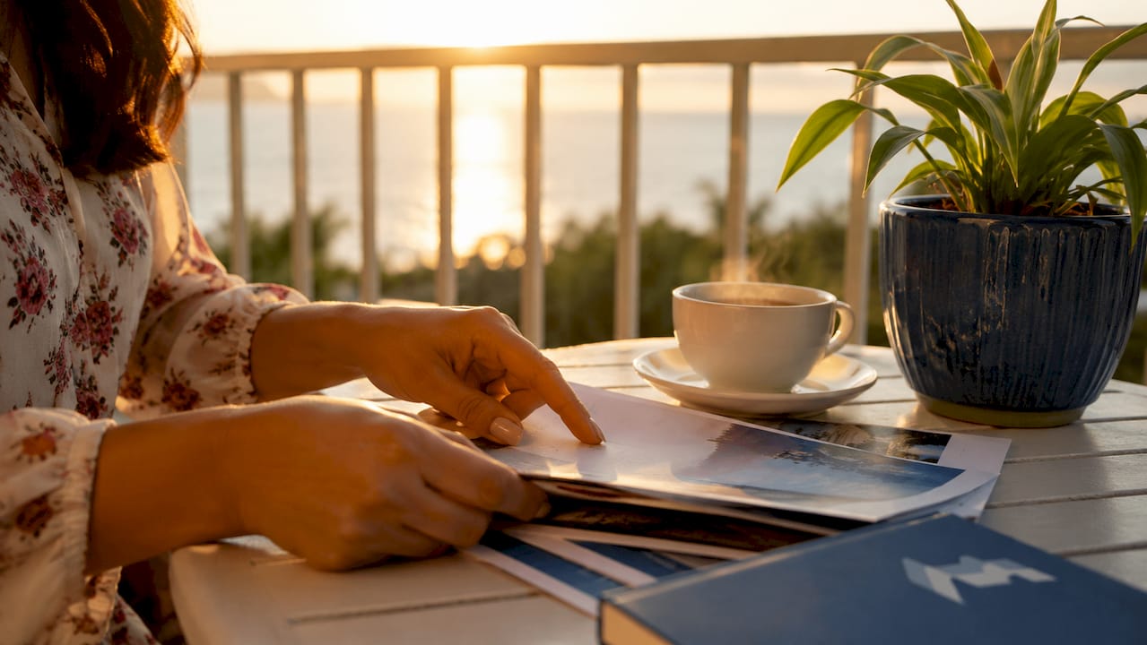 Hands holding cruise deposit informational leaflets