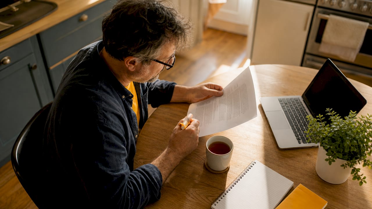 Landlord reviewing lease agreement at desk