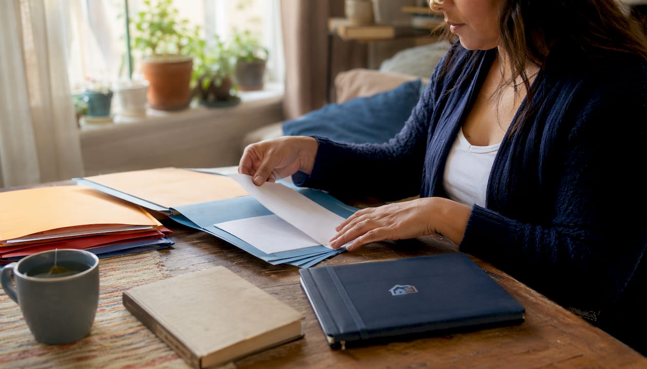 Hands sorting rental and personal financial documents