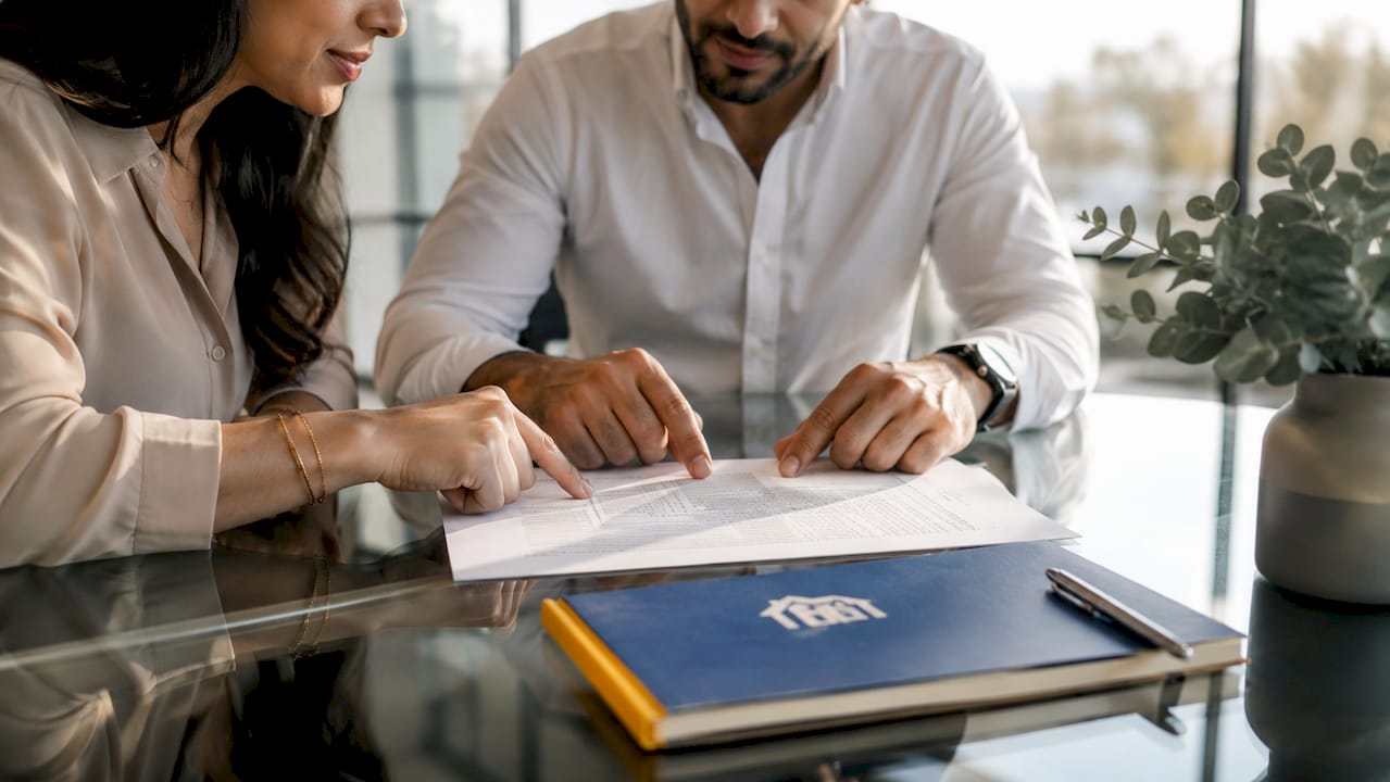 Close-up of hands reviewing lease agreement