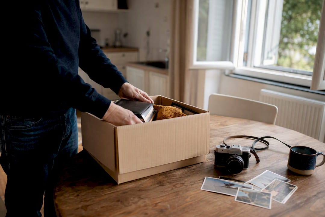 Landlord packing tenant belongings in empty unit
