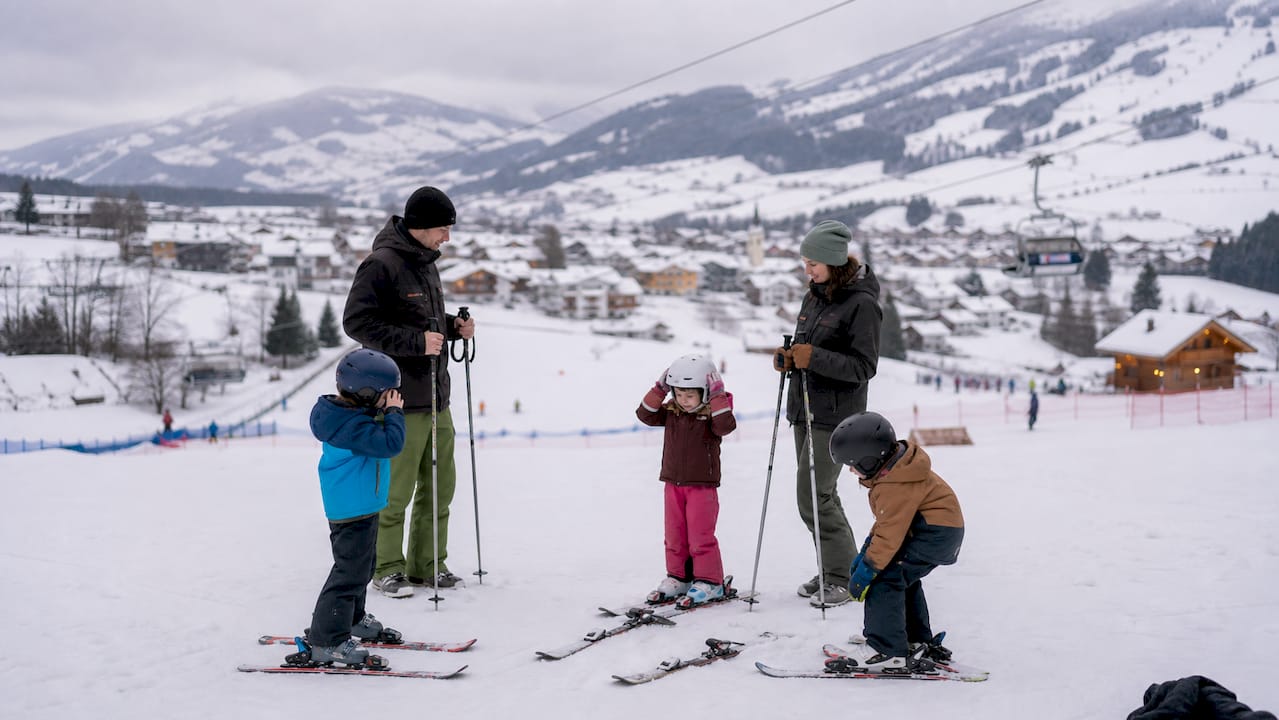 Family with children ready to ski on a gentle slope