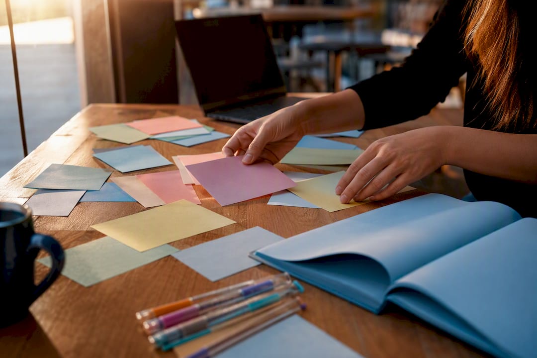 Hands adjusting keyword index cards on desk