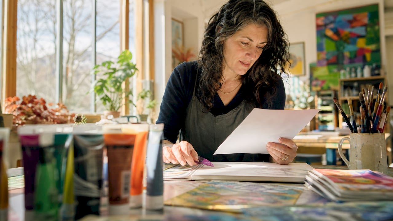 Teacher reviewing scaffolding lesson materials at desk