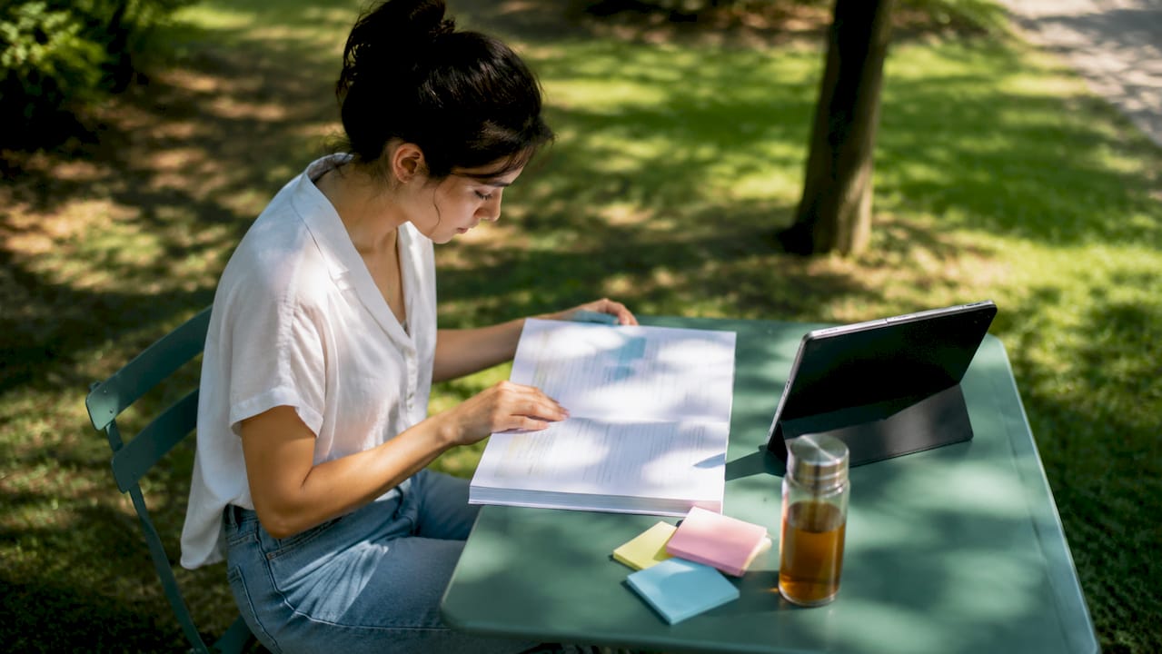 Person reviewing TEFL certification documents at desk