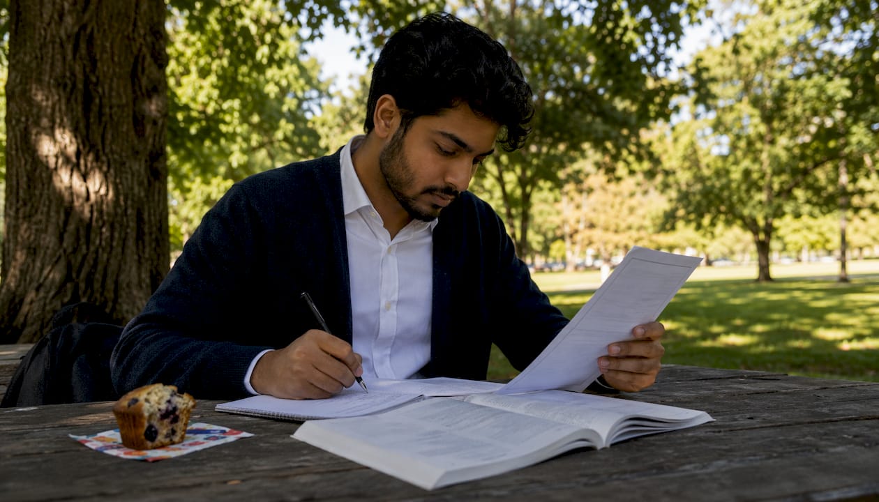 Man making notes on TEFL diploma in café
