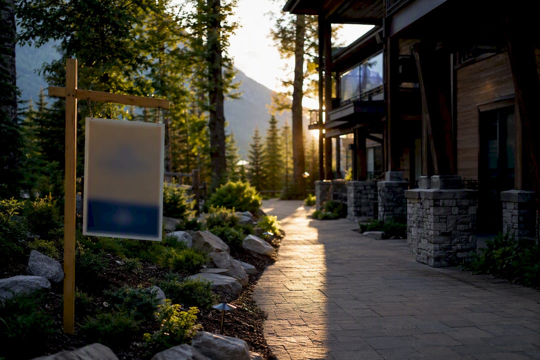 Condo walkway with for-sale sign in mountain resort