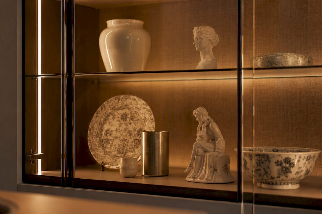 Display cabinet lit with warm LED lights highlighting materials