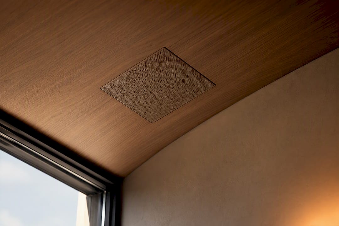 Speaker grille coordinated with warm wood ceiling