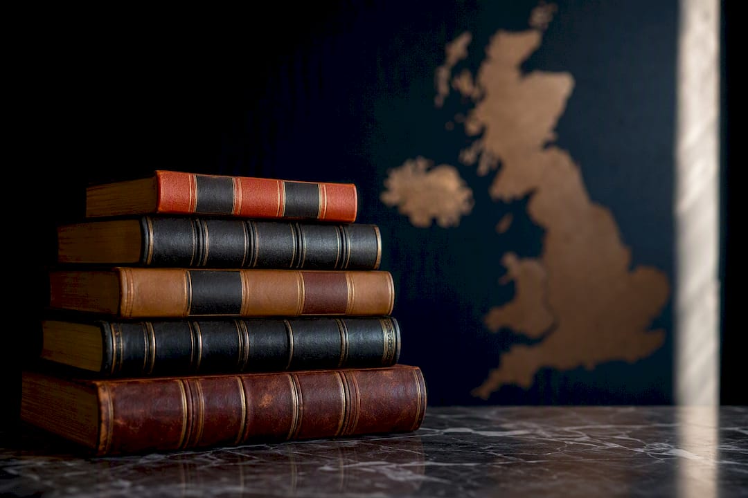 Stacked legal books with dark navy backdrop