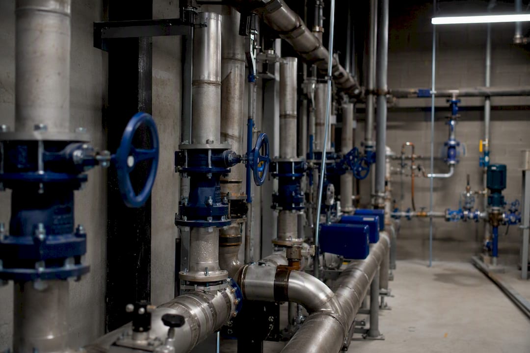 Close-up of plumbing pipes and valves in building