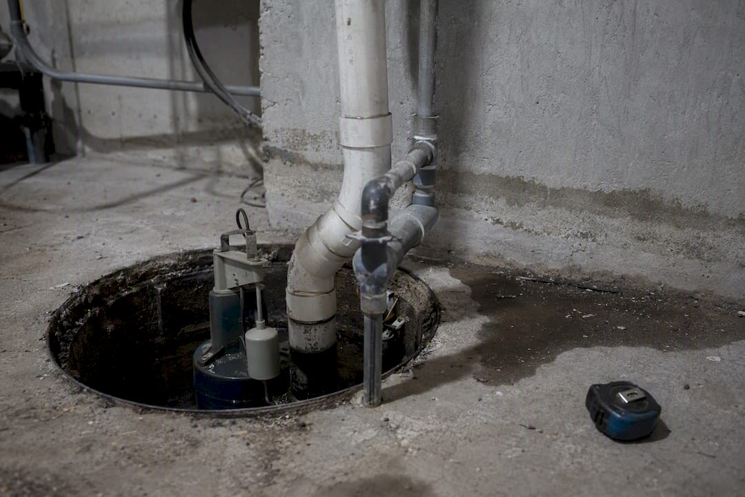 sump pump basin with pump and piping