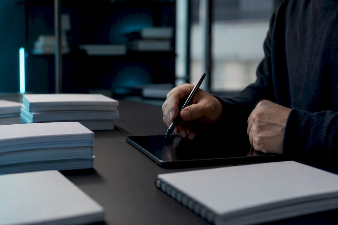 Hands poised for detailed manual editing work