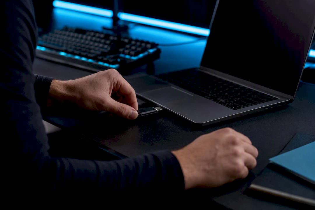 Developer hands connecting USB drive for localization syncing