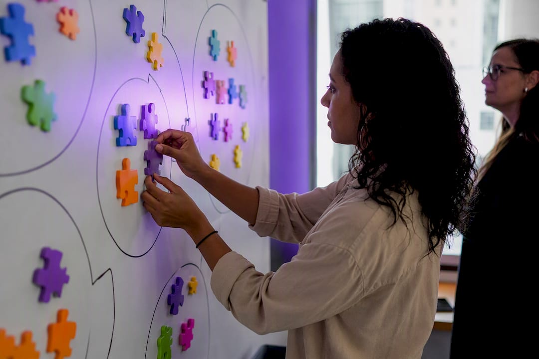 Hands placing audience targeting puzzle pieces