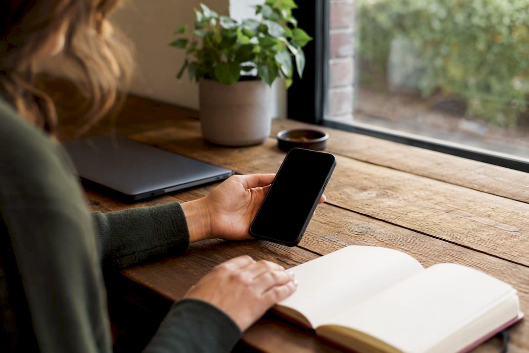 Hand holding smartphone starting onboarding process