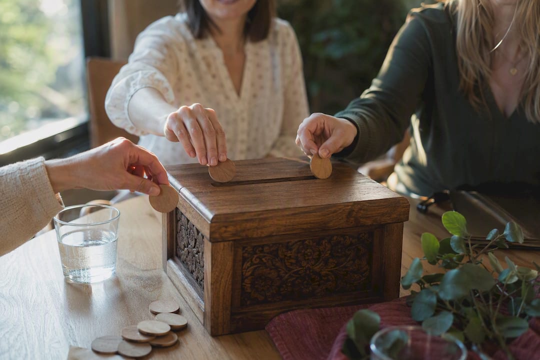 Hands casting votes into ballot box