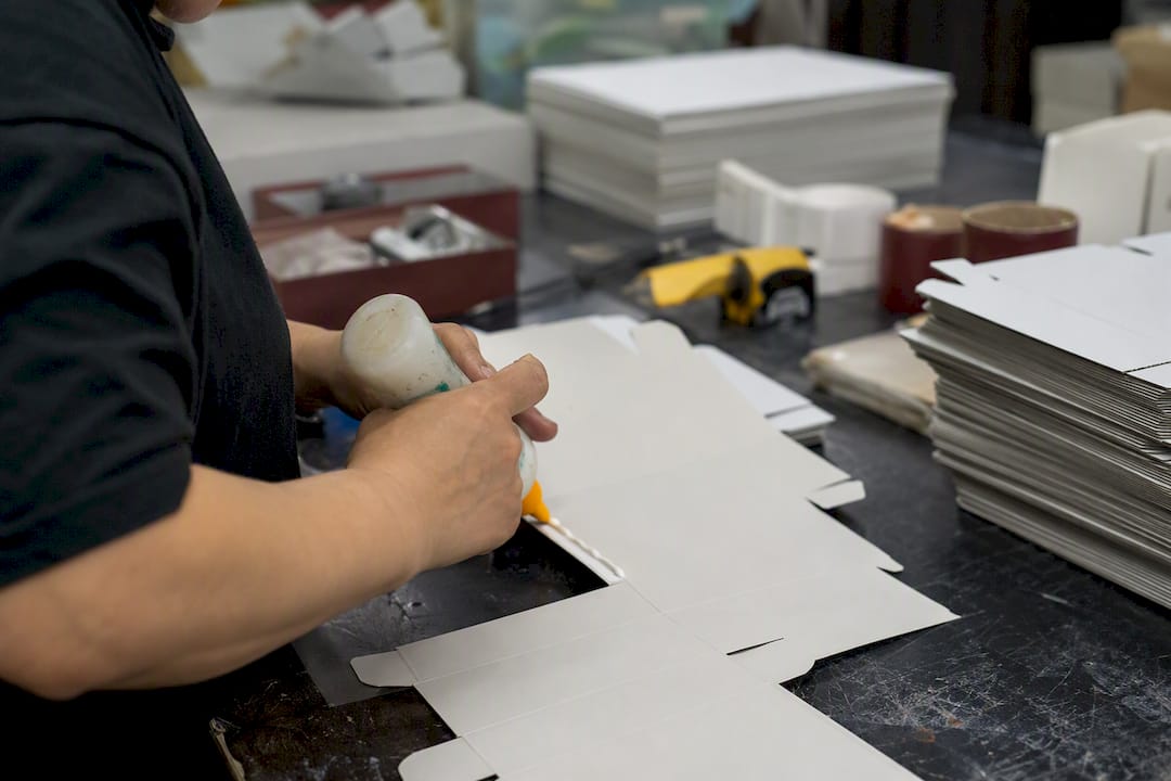 Applying adhesive to carton glue flap