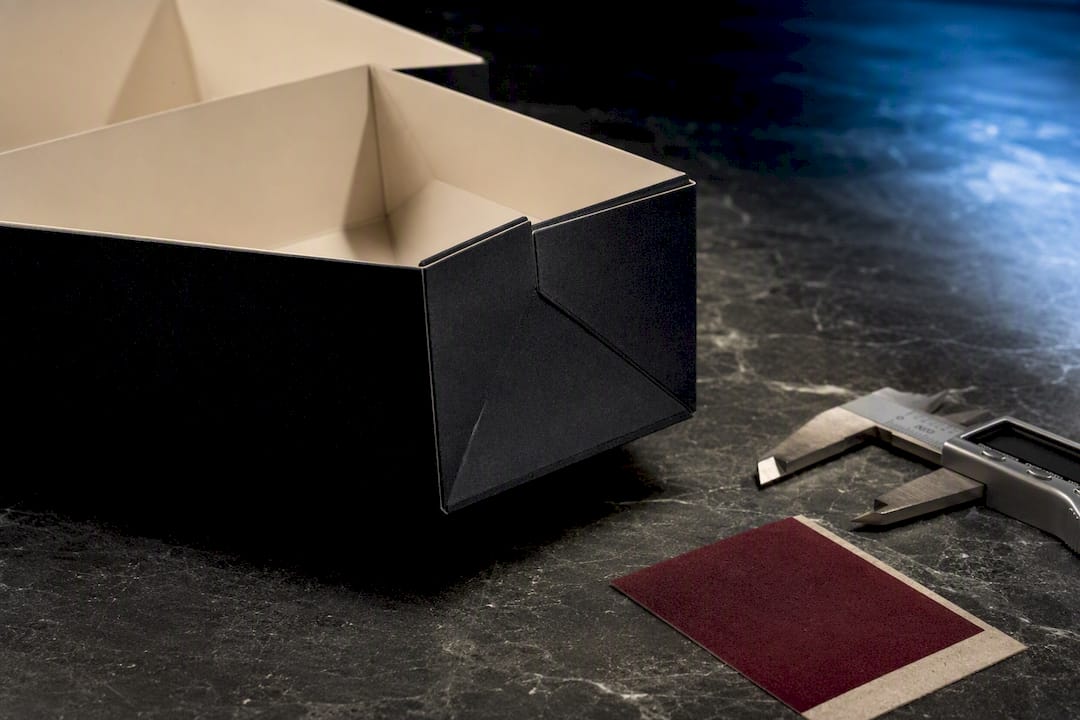 Partial luxury fragrance carton under inspection