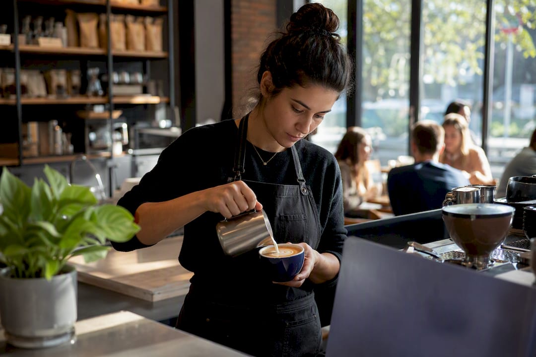 Barista tamping coffee grounds