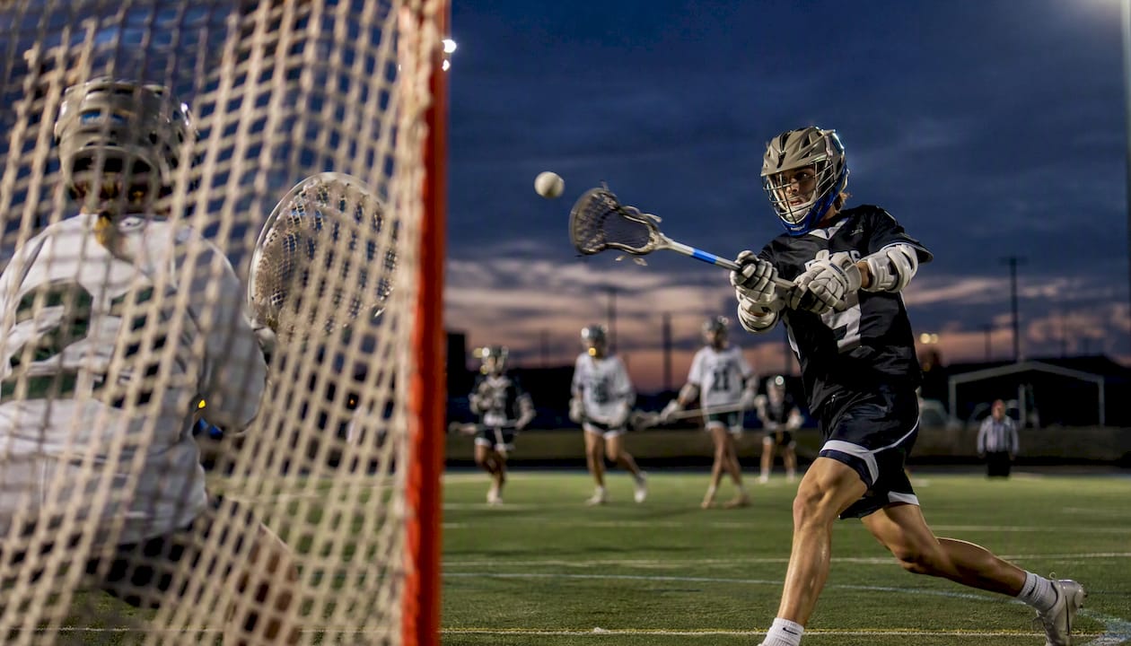 Lacrosse player shooting during competitive game