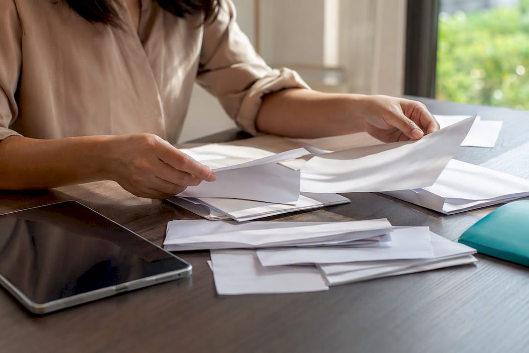 Hands sorting bank statements on desk