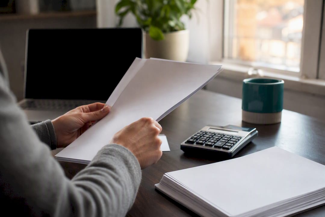 Hands organizing profit and loss statement and bank statements