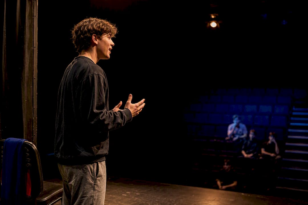 Teen performer projecting a monologue onstage