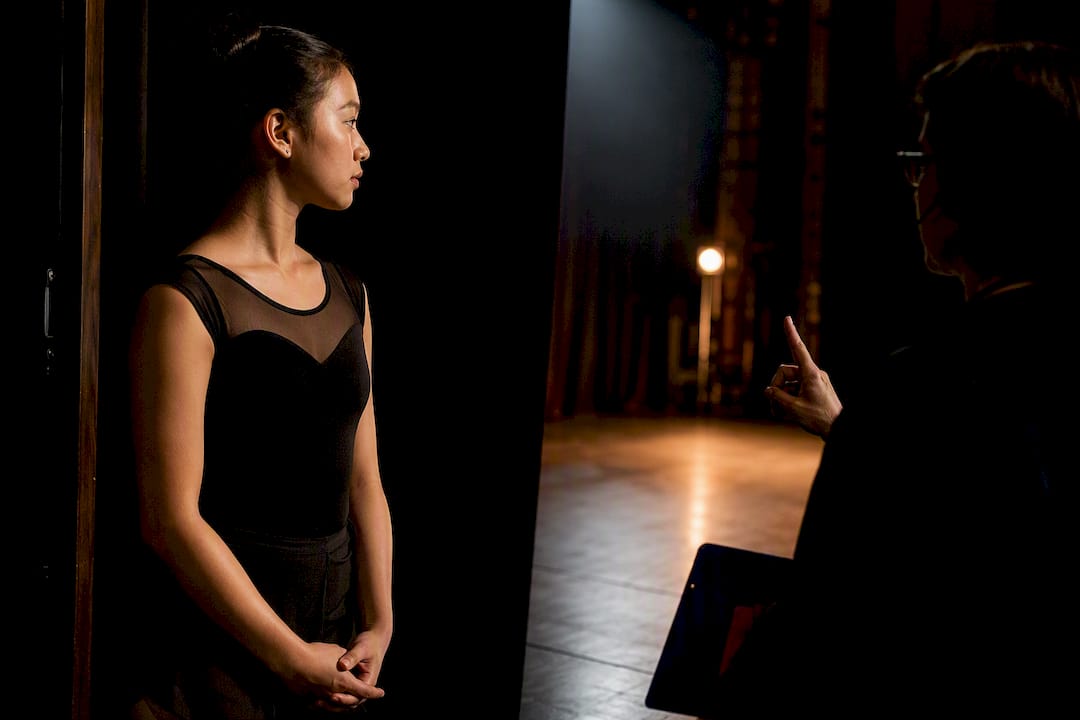 Performer receiving a backstage cue