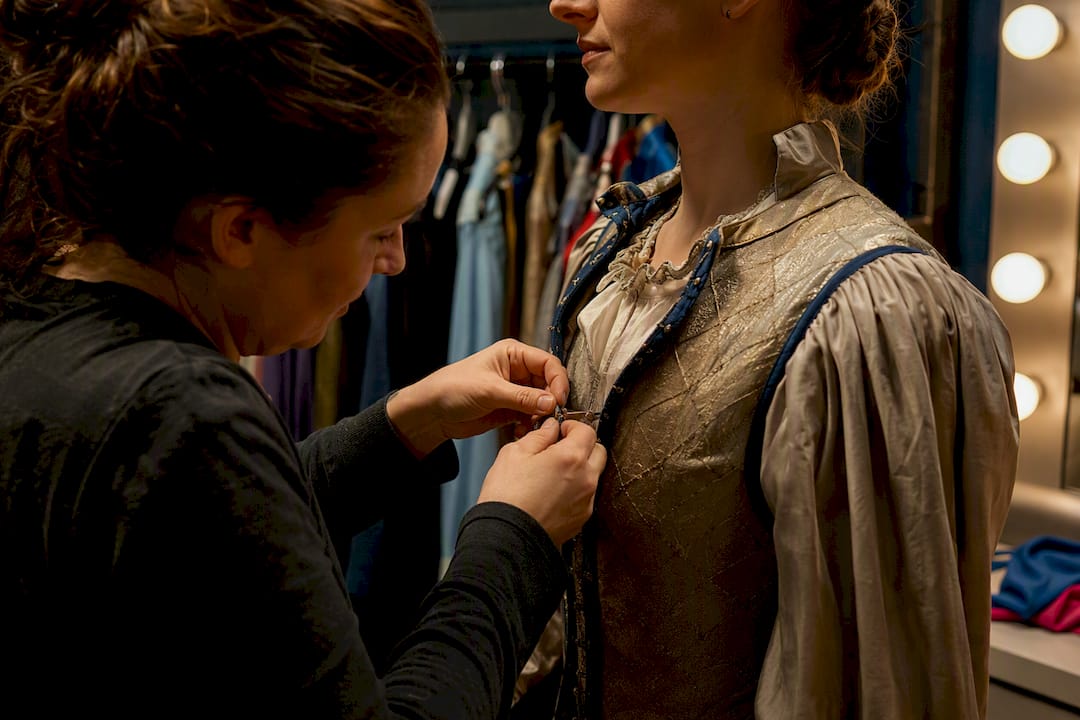 Dresser assisting a backstage quick change